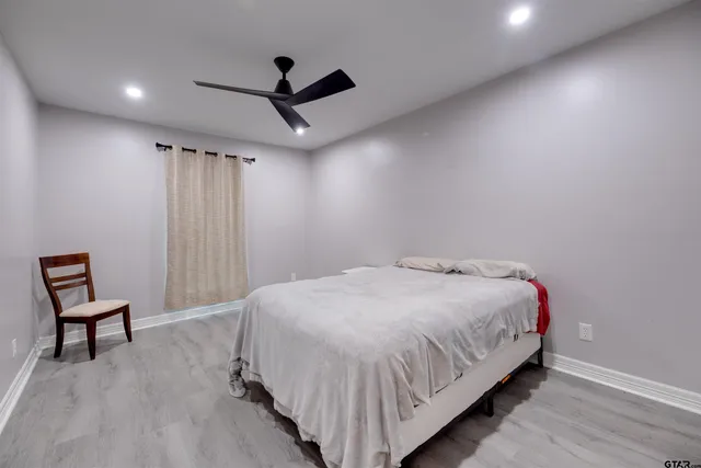 a bedroom with a bed and a chair