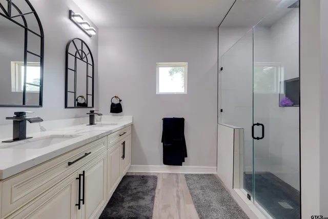 a spacious bathroom with a double vanity sink and a mirror