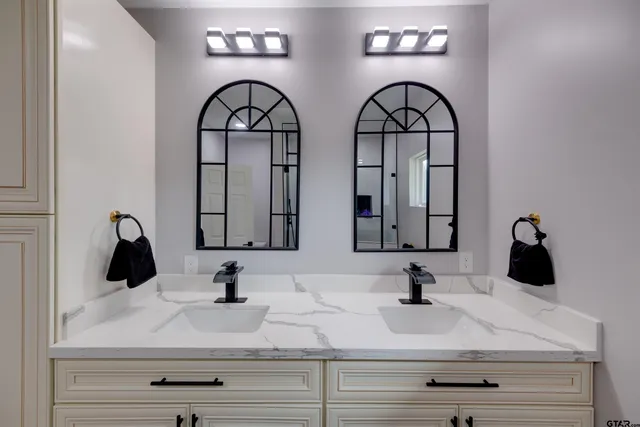 a kitchen with a sink and a mirror
