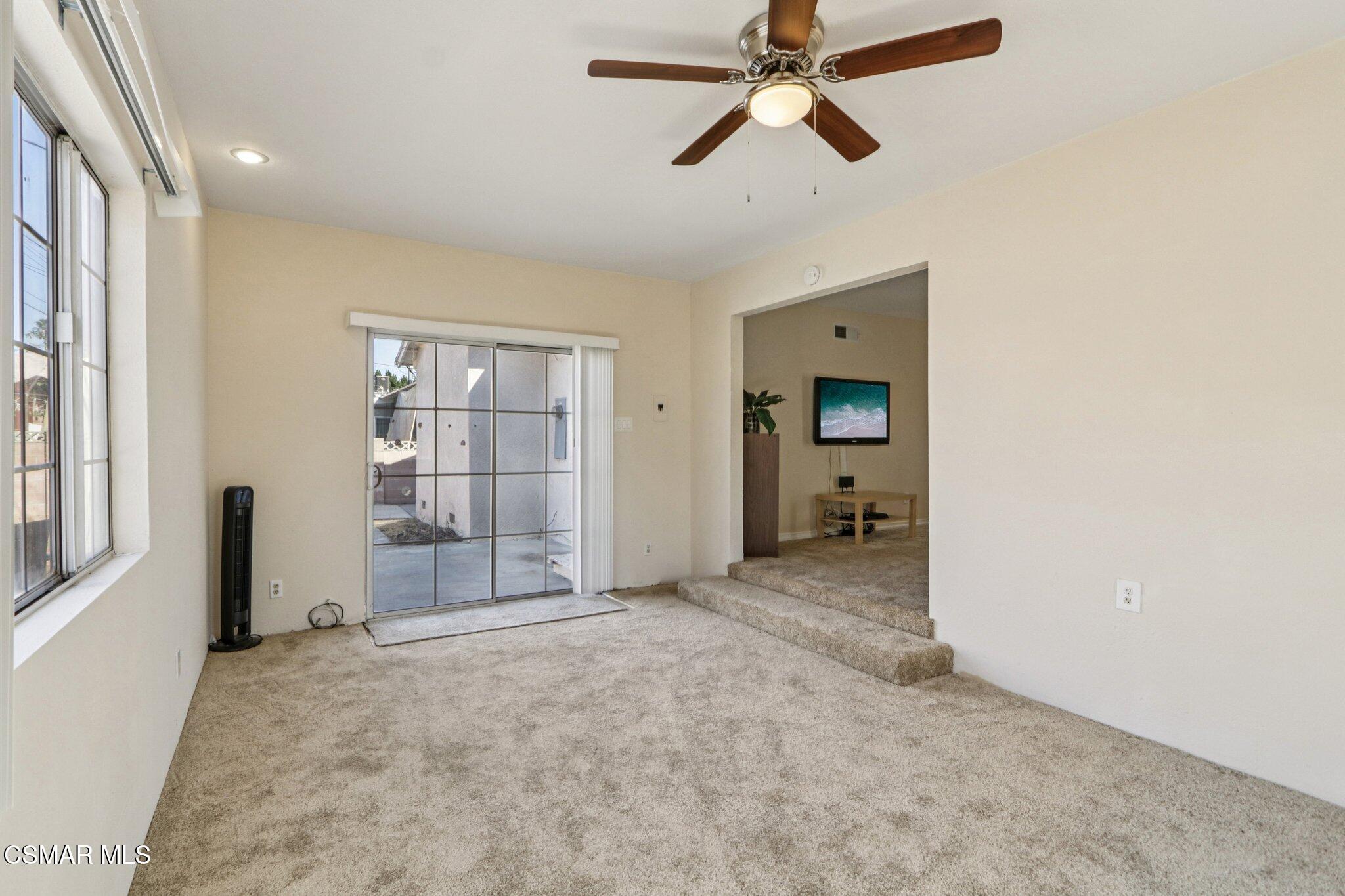 12745 Muscatine Street Pacoima, CA 91331 - Photo 13 of 35 an empty room with chandelier fan and windows