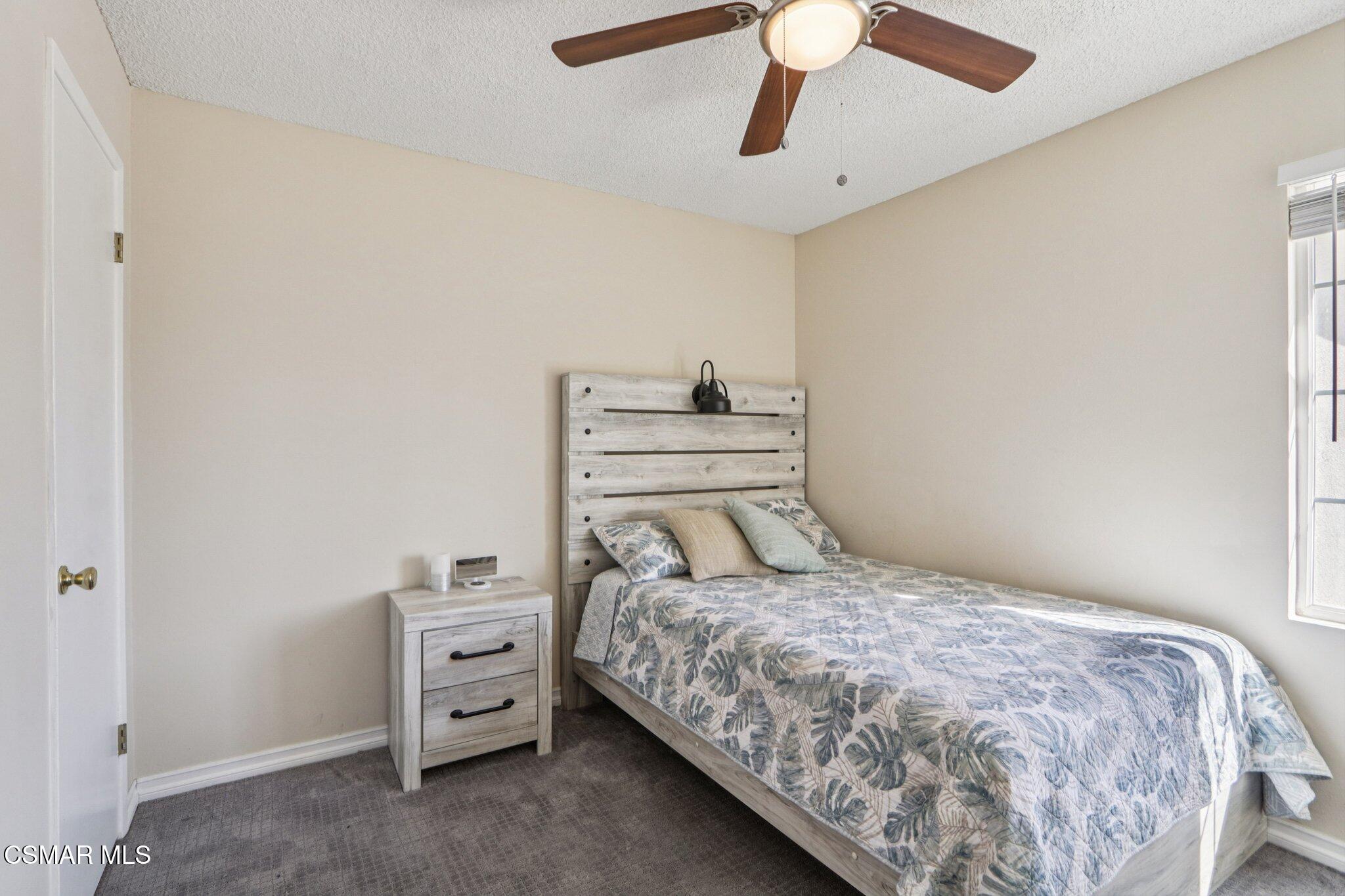 12745 Muscatine Street Pacoima, CA 91331 - Photo 17 of 35 a bedroom with a bed and a chandelier