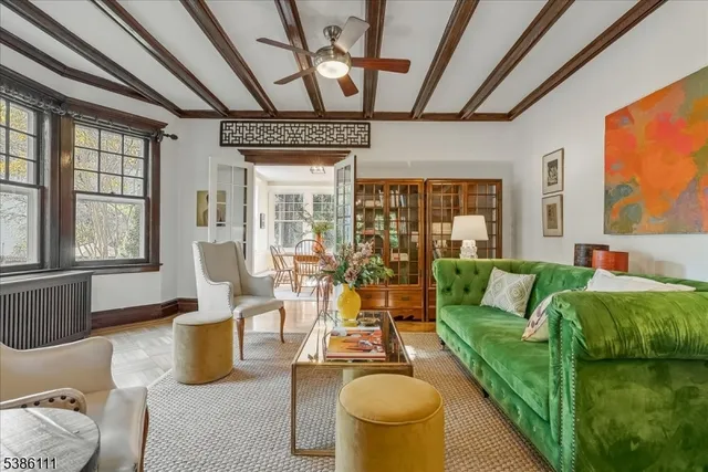 a living room with furniture and a floor to ceiling window