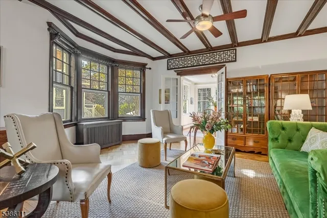 a living room with furniture and a floor to ceiling window