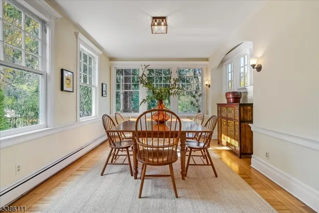a view of a dining room with furniture and chandelier
