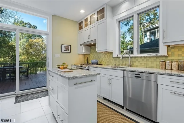 a kitchen with stainless steel appliances a refrigerator sink and cabinets