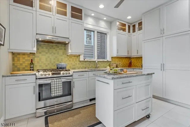 a kitchen with a sink stove and cabinets