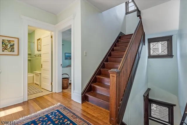 a bedroom with a bed window and wooden floor