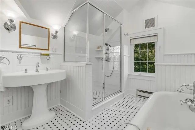 a bedroom with a bed and a chair with the view of bathroom