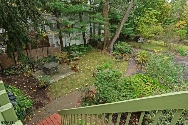 a view of a backyard with large trees