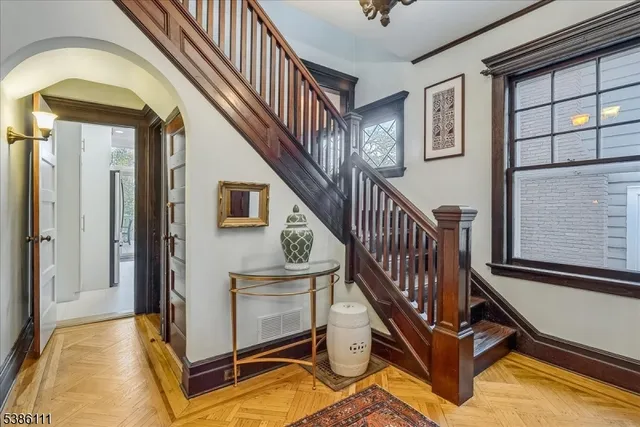 a view of entryway and hall with wooden floor