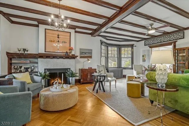 a living room with furniture a fireplace and a large window