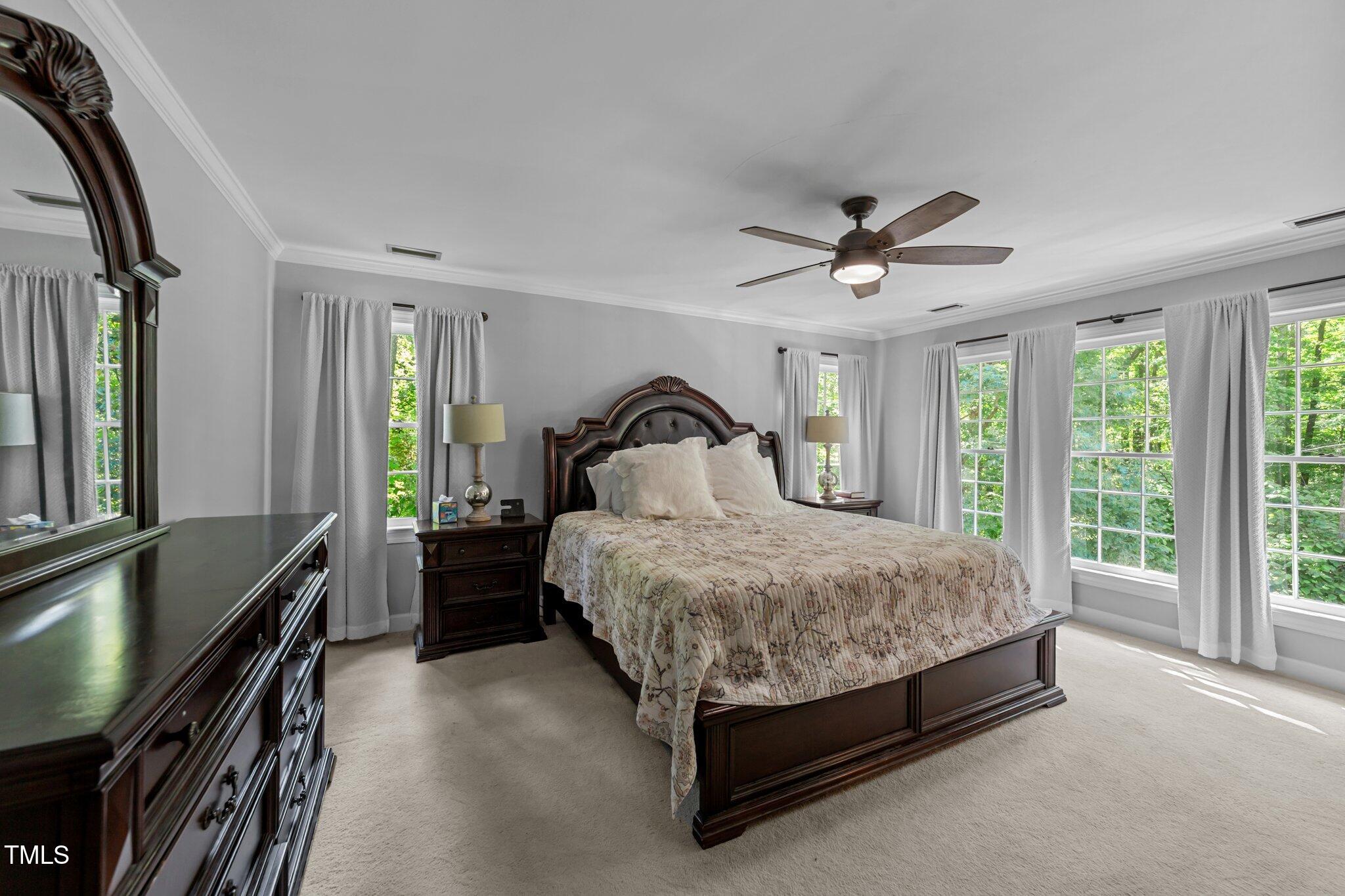2409 Beechview Court Raleigh, NC 27615 - Photo 21 of 46 a bed sitting in a bedroom next to a window