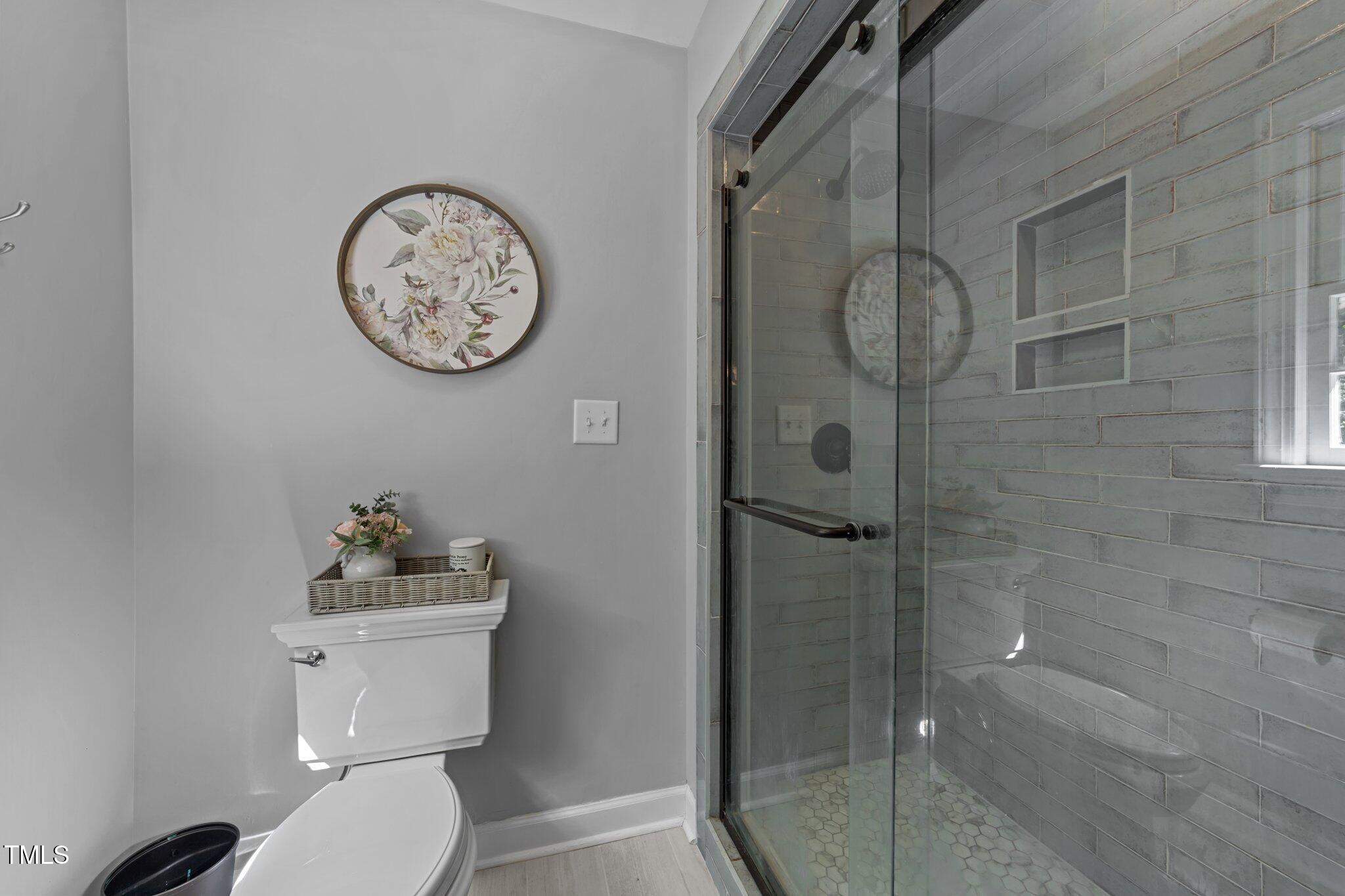 2409 Beechview Court Raleigh, NC 27615 - Photo 23 of 46 a bathroom with a toilet and a shower