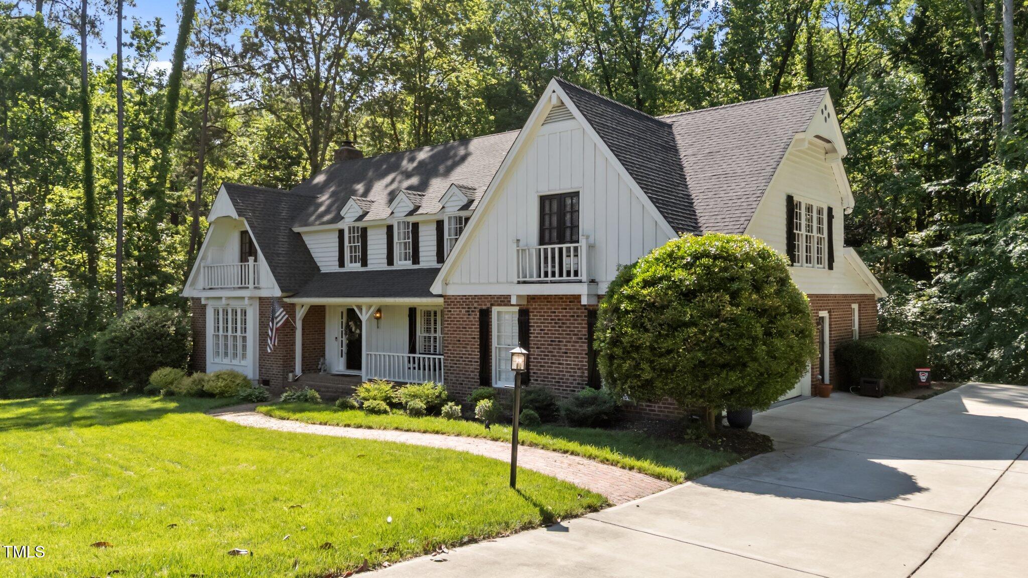 2409 Beechview Court Raleigh, NC 27615 - Photo 3 of 46 a view of a white house with a yard plants and large tree