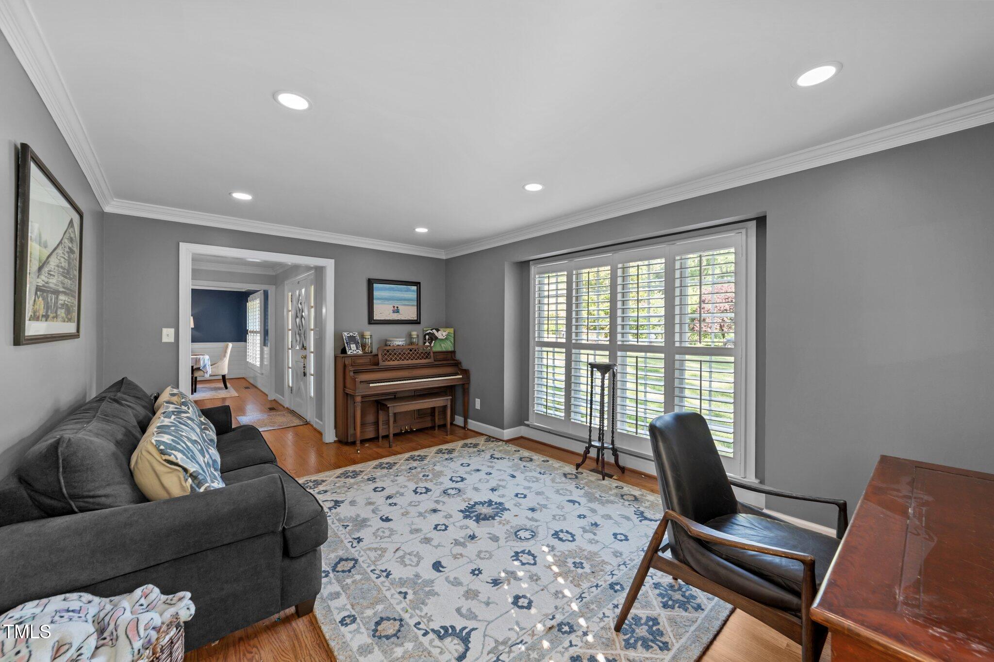 2409 Beechview Court Raleigh, NC 27615 - Photo 6 of 46 a living room with furniture and a flat screen tv