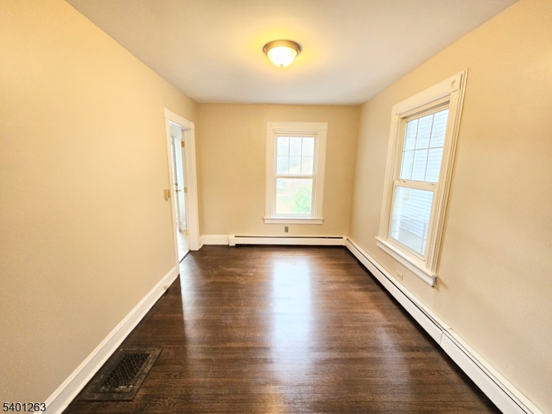 232 Morris Avenue Summit, NJ 07901 - Photo 5 of 13 a view of an empty room with wooden floor and a window