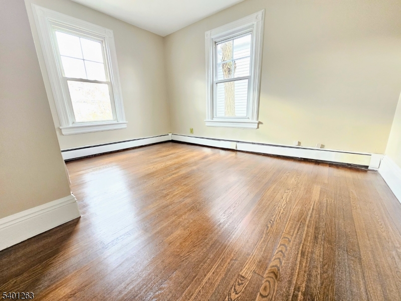 232 Morris Avenue Summit, NJ 07901 - Photo 6 of 13 an empty room with wooden floor and windows