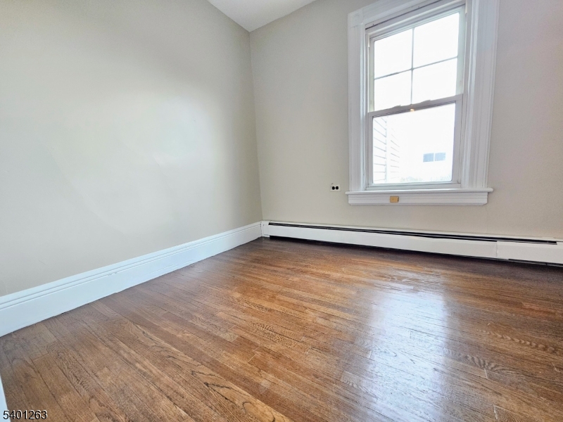 232 Morris Avenue Summit, NJ 07901 - Photo 8 of 13 an empty room with wooden floor and windows