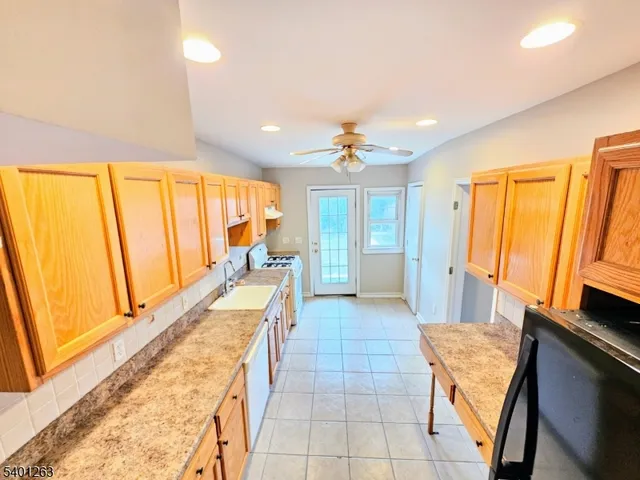 a large white kitchen with a large window