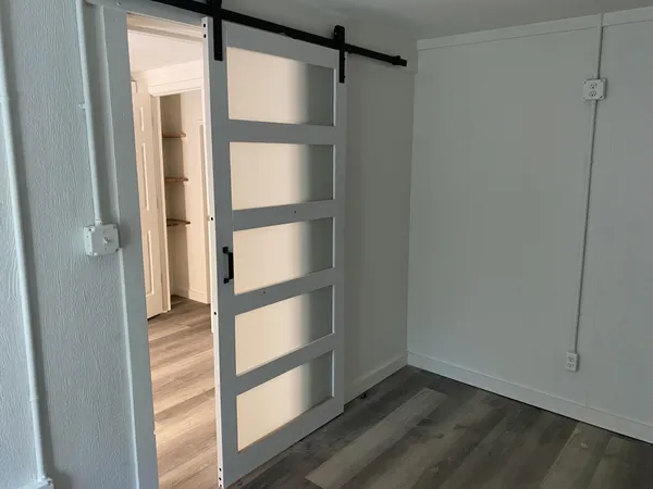 a view of walk in closet with empty racks