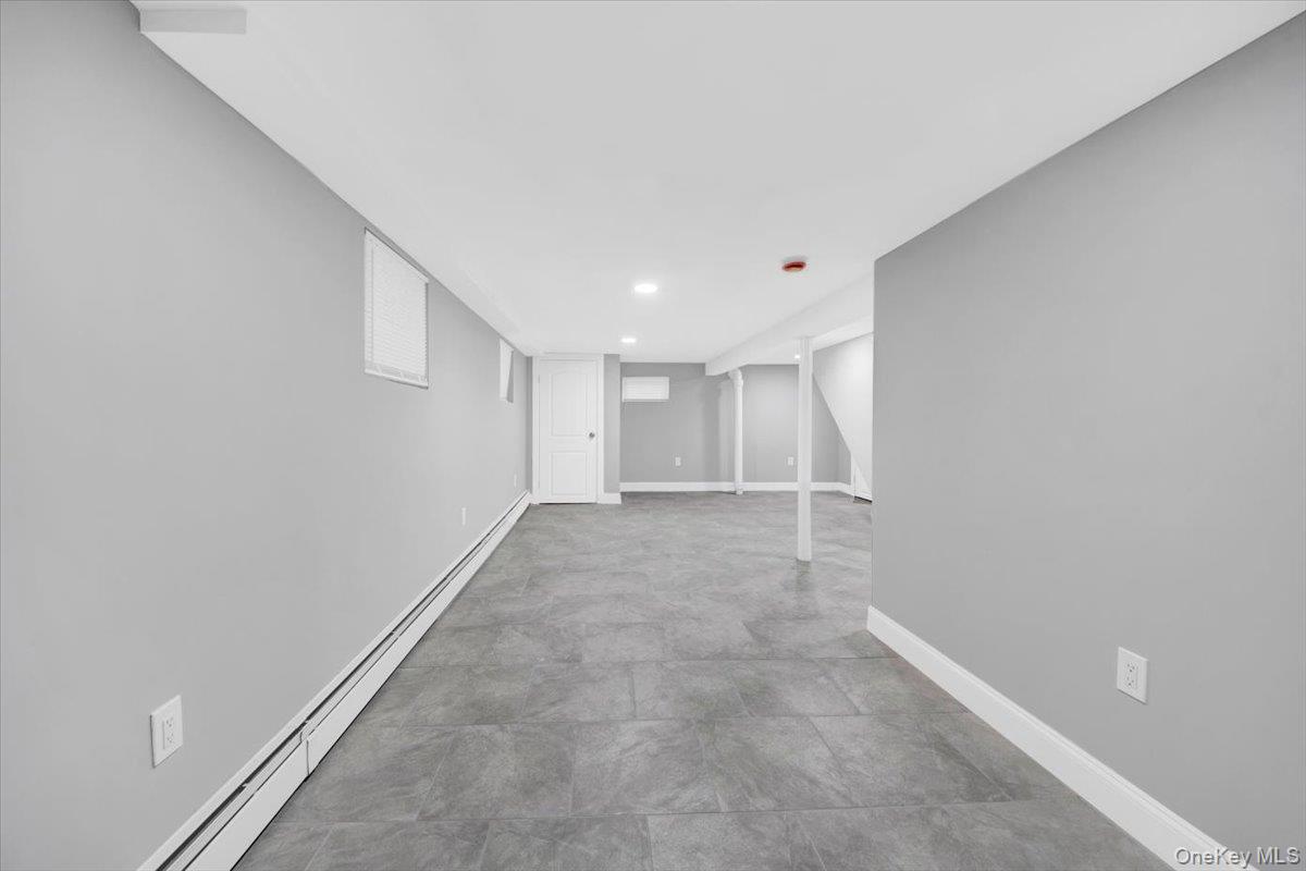 2886 Randall Avenue Bronx, NY 10465 - Photo 15 of 26 Finished area with a baseboard heating unit and recessed lighting