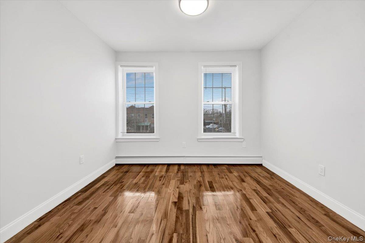 2886 Randall Avenue Bronx, NY 10465 - Photo 19 of 26 bedroom featuring new oak finished flooring and baseboard heating
