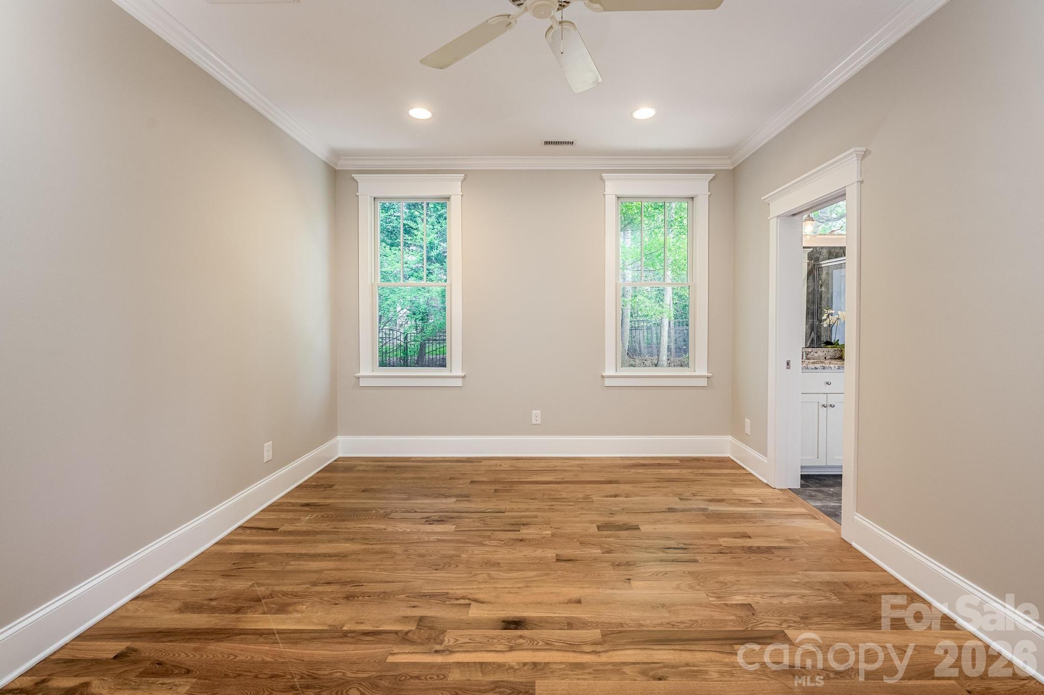 735 Emma Claire Lane Davidson, NC 28036 - Photo 17 of 48 a view of an empty room with wooden floor and a window