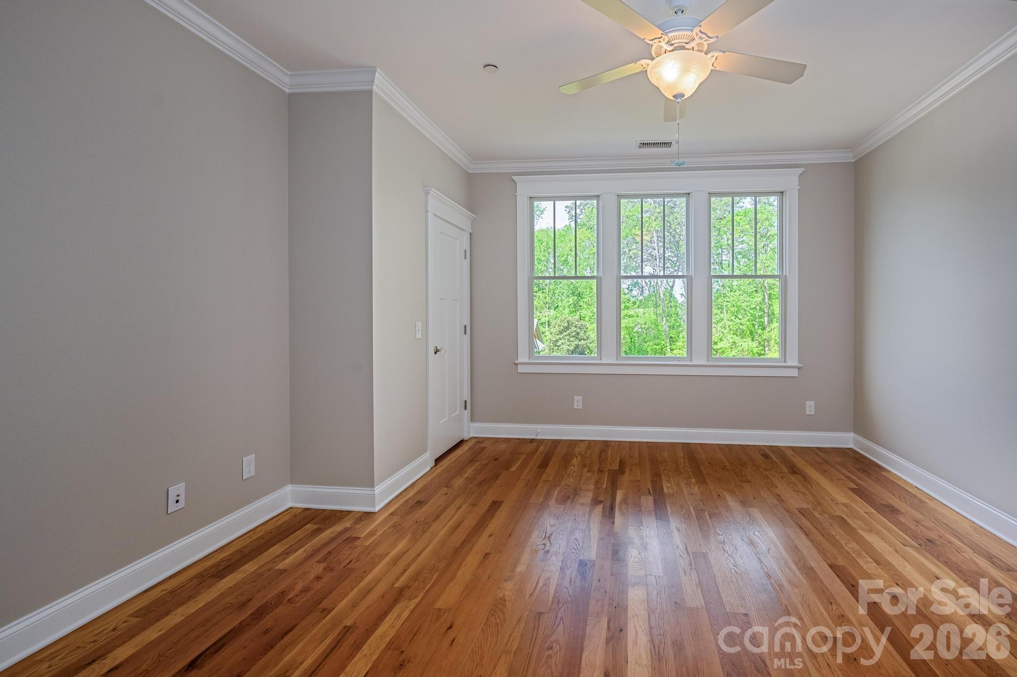 735 Emma Claire Lane Davidson, NC 28036 - Photo 23 of 48 an empty room with wooden floor and windows