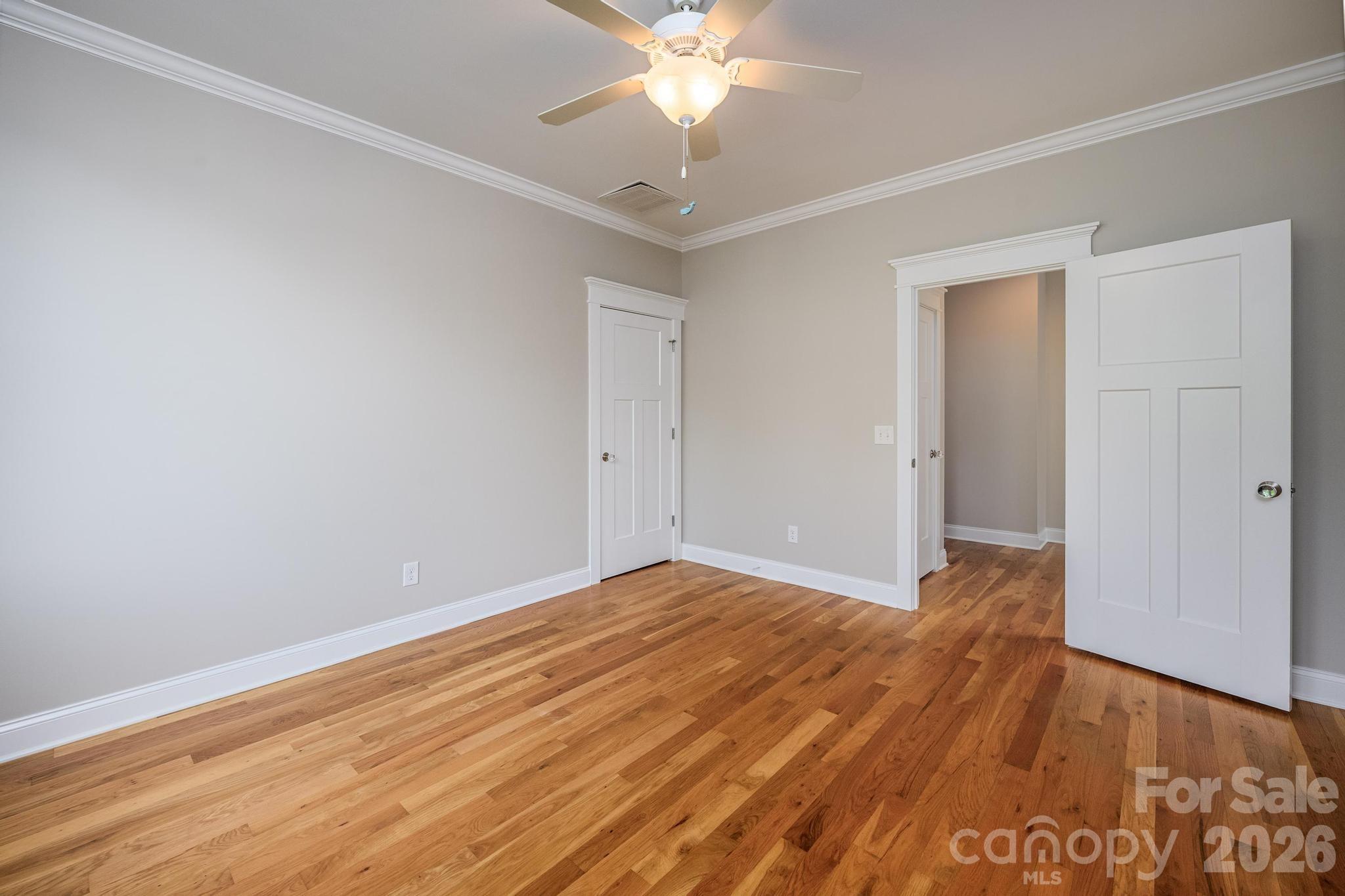 735 Emma Claire Lane Davidson, NC 28036 - Photo 24 of 48 a view of a room with wooden floor and a ceiling fan