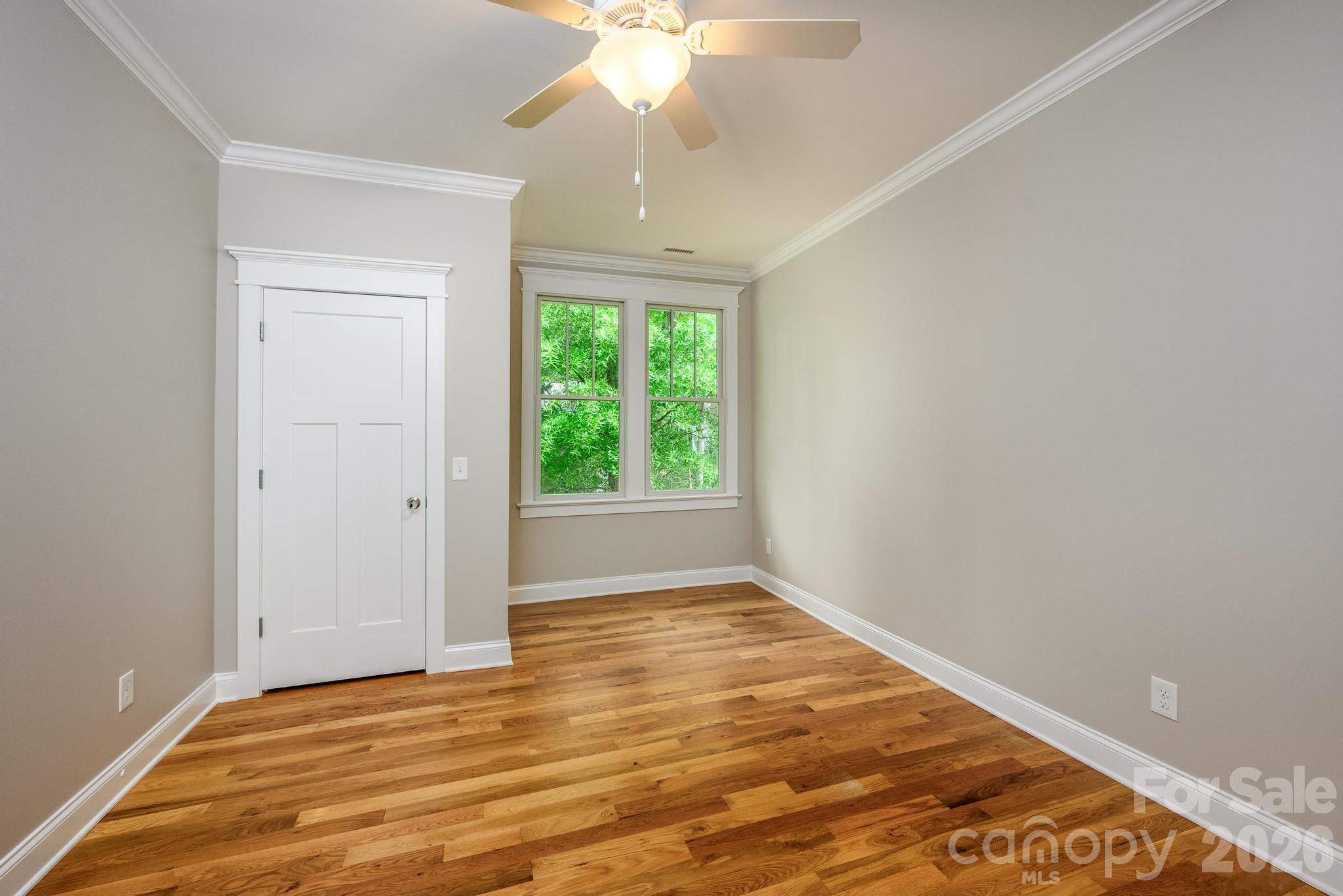 735 Emma Claire Lane Davidson, NC 28036 - Photo 25 of 48 a view of an empty room with wooden floor and a window