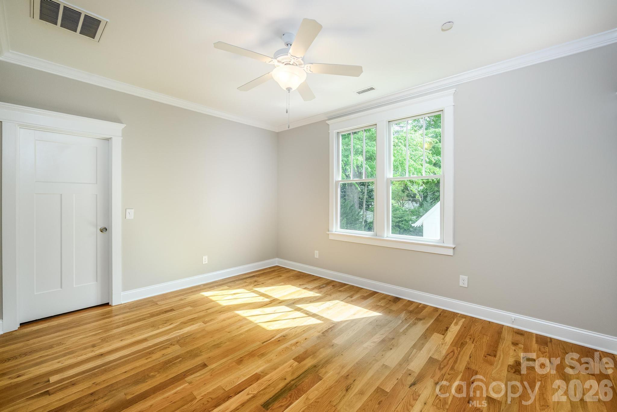 735 Emma Claire Lane Davidson, NC 28036 - Photo 27 of 48 a view of an empty room with wooden floor and a window