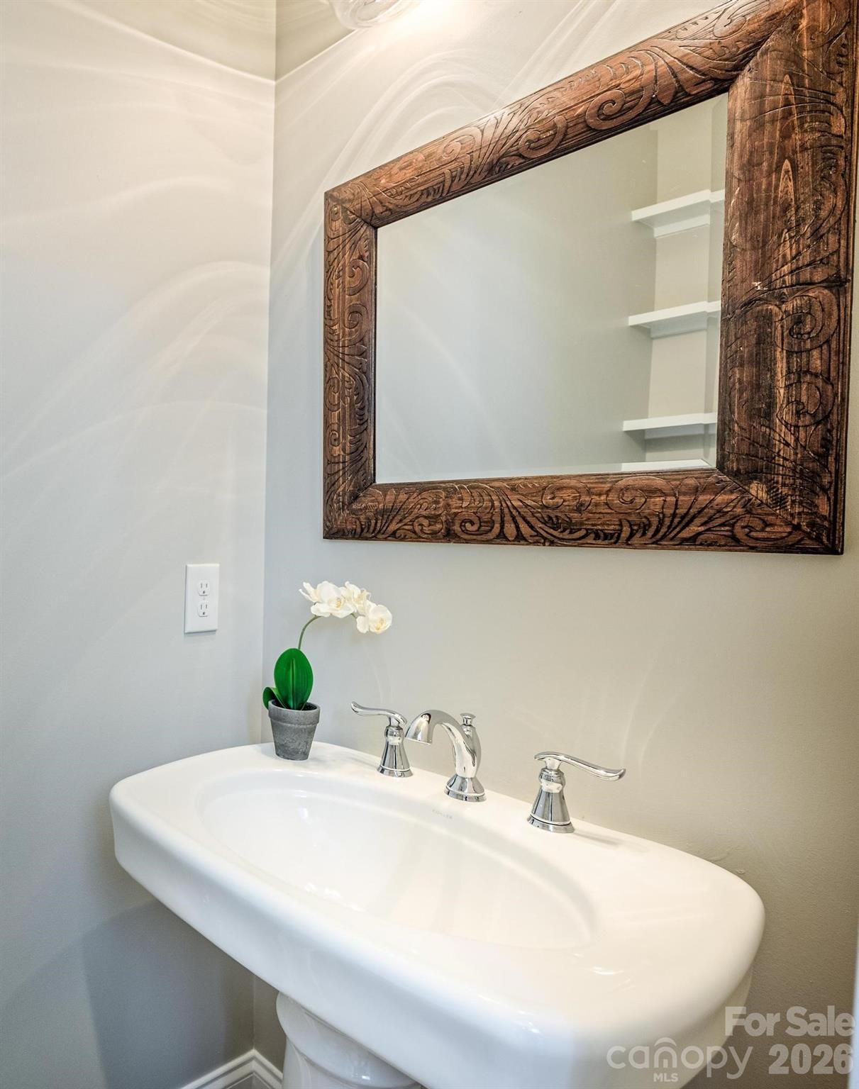735 Emma Claire Lane Davidson, NC 28036 - Photo 31 of 48 a bathroom with a sink and a mirror