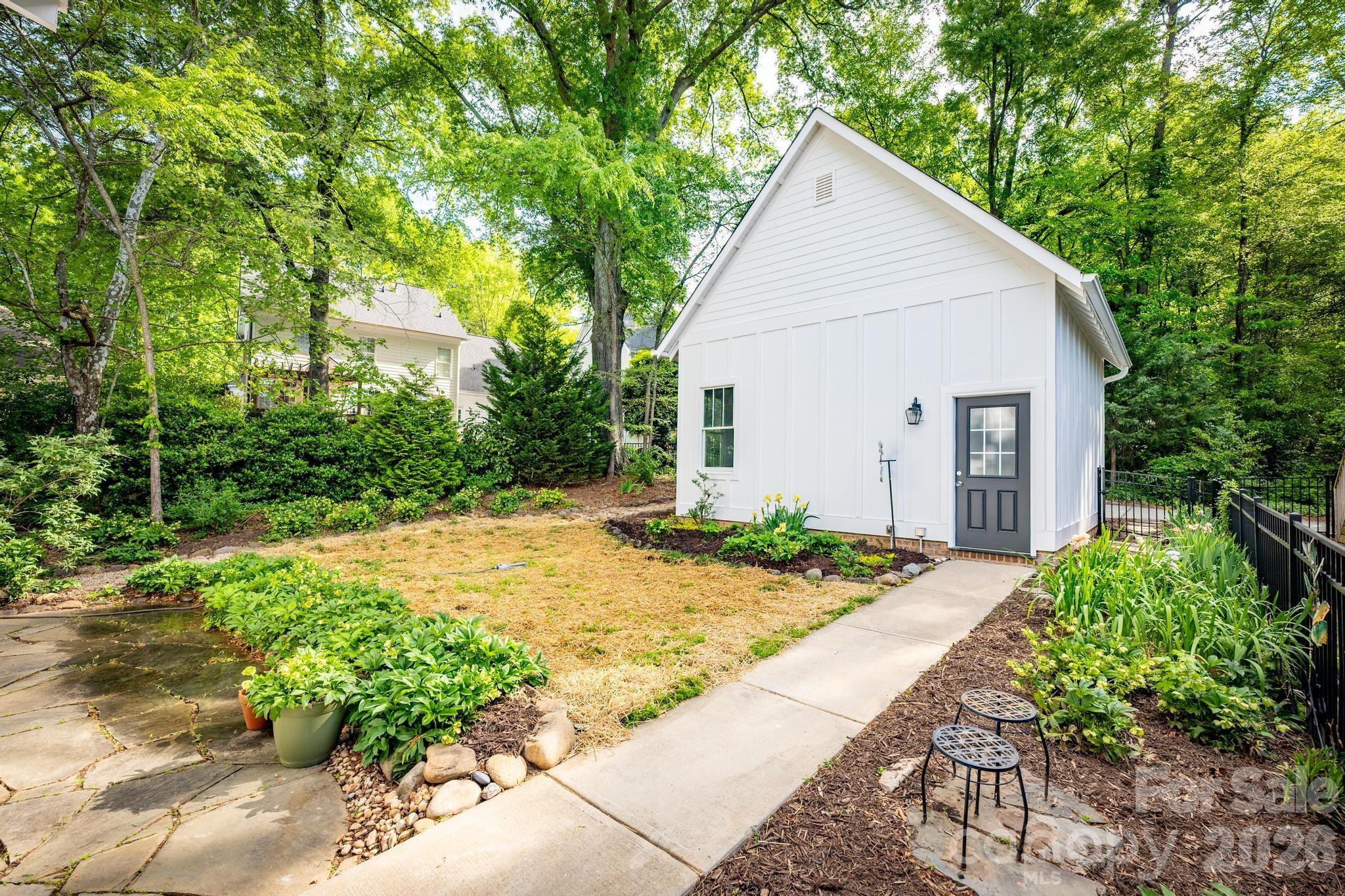 735 Emma Claire Lane Davidson, NC 28036 - Photo 35 of 48 a view of backyard of house with green space and trees in the background