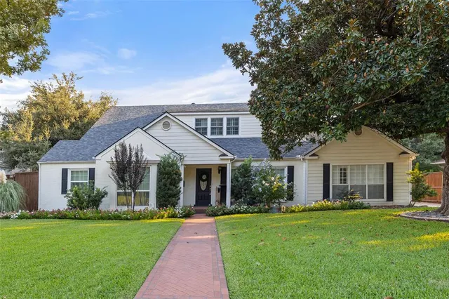 a front view of a house with a garden and porch