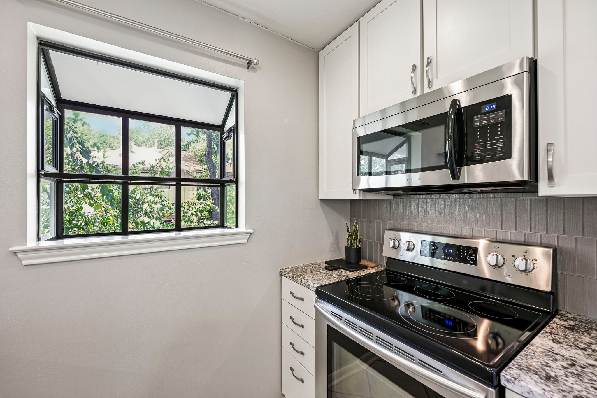 2412 Enfield Road, Unit 8 Austin, TX 78703 - Photo 18 of 34 That kitchen window may be one of my favorite details. Even sautéing veggies comes with a side of Tarrytown greenery.