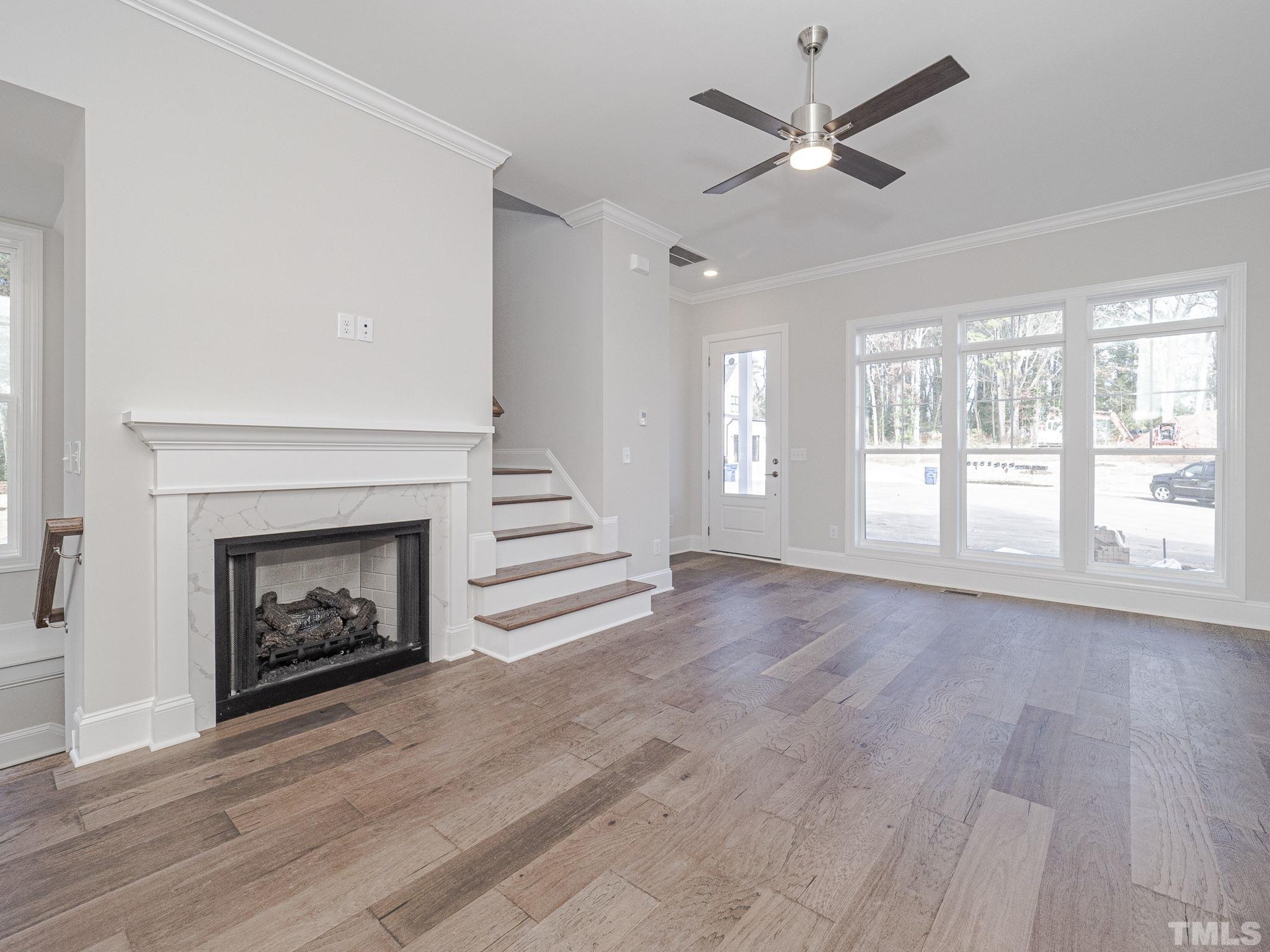 4920 Trek Lane Raleigh, NC 27606 - Photo 11 of 31 a view of an empty room with a fireplace and a window