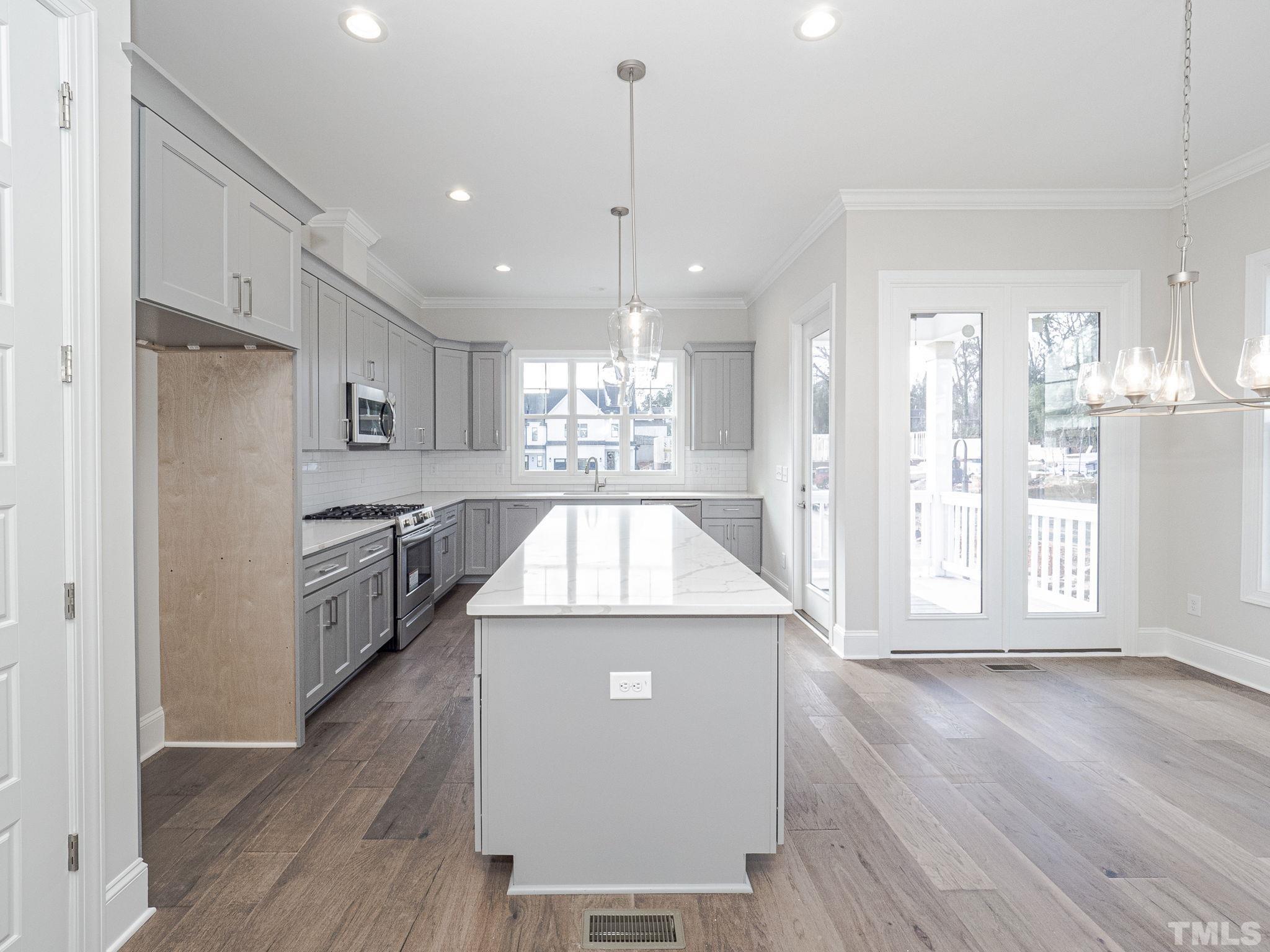 4920 Trek Lane Raleigh, NC 27606 - Photo 15 of 31 a kitchen with a refrigerator a sink and cabinets