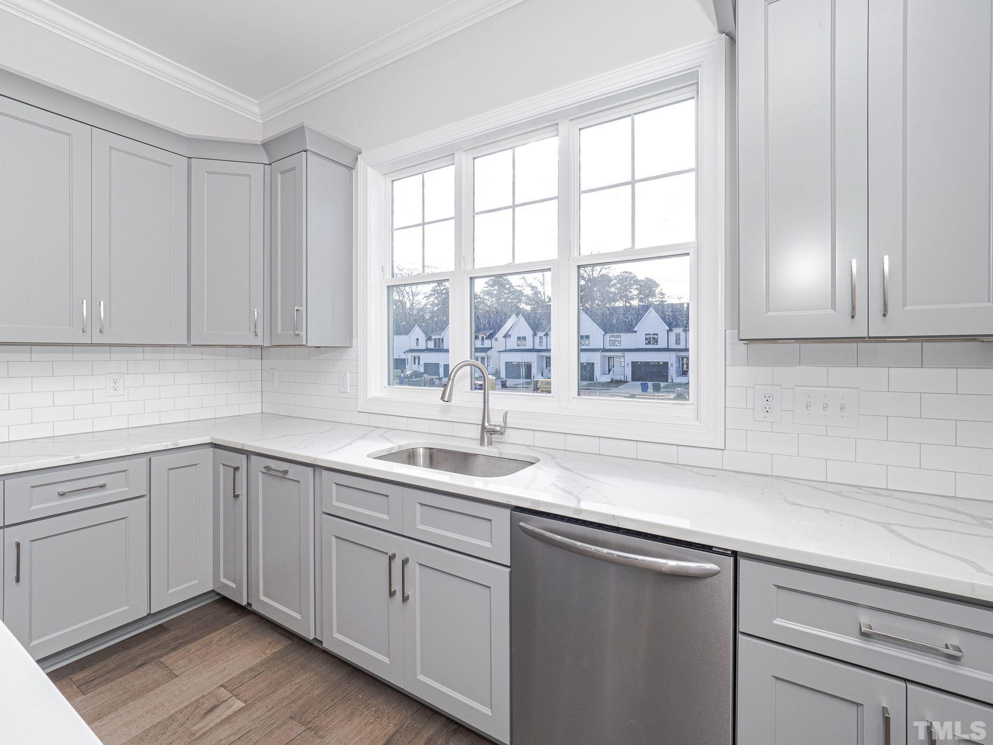 4920 Trek Lane Raleigh, NC 27606 - Photo 17 of 31 a kitchen with a sink cabinets and window