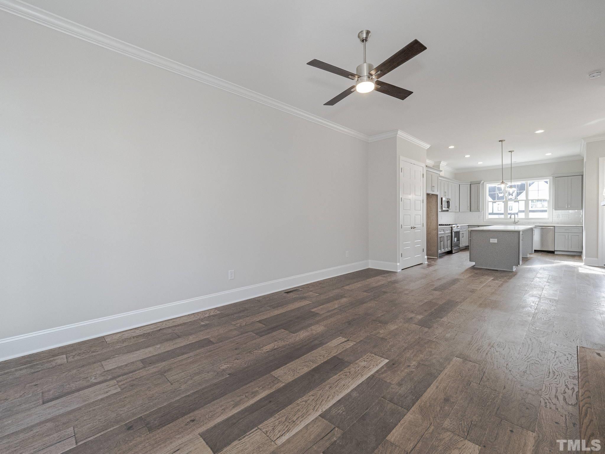 4920 Trek Lane Raleigh, NC 27606 - Photo 18 of 31 a view of a livingroom with a hardwood floor and a ceiling fan