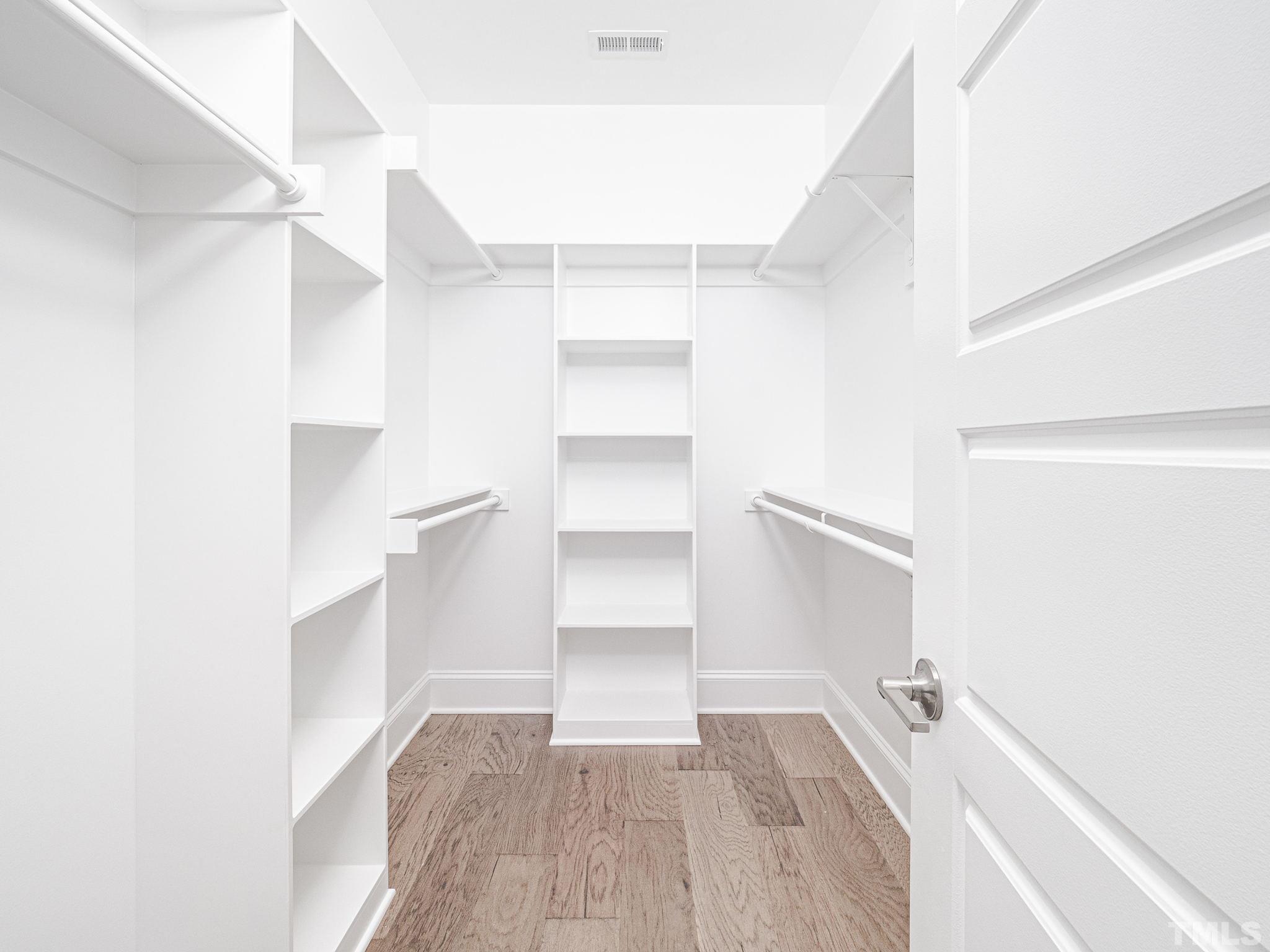 4920 Trek Lane Raleigh, NC 27606 - Photo 22 of 31 a view of walk in closet with empty racks