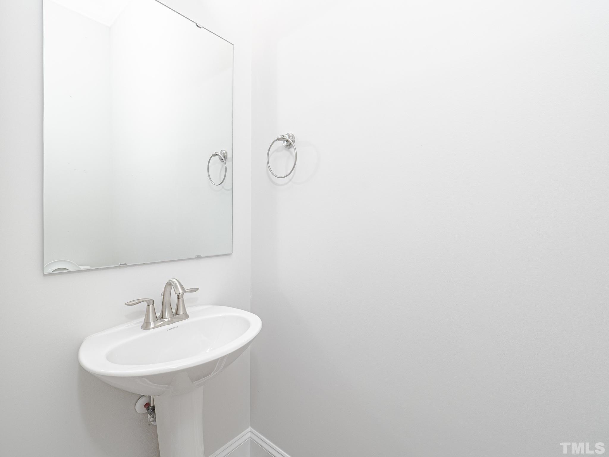 4920 Trek Lane Raleigh, NC 27606 - Photo 27 of 31 a bathroom with a sink a mirror and a shower