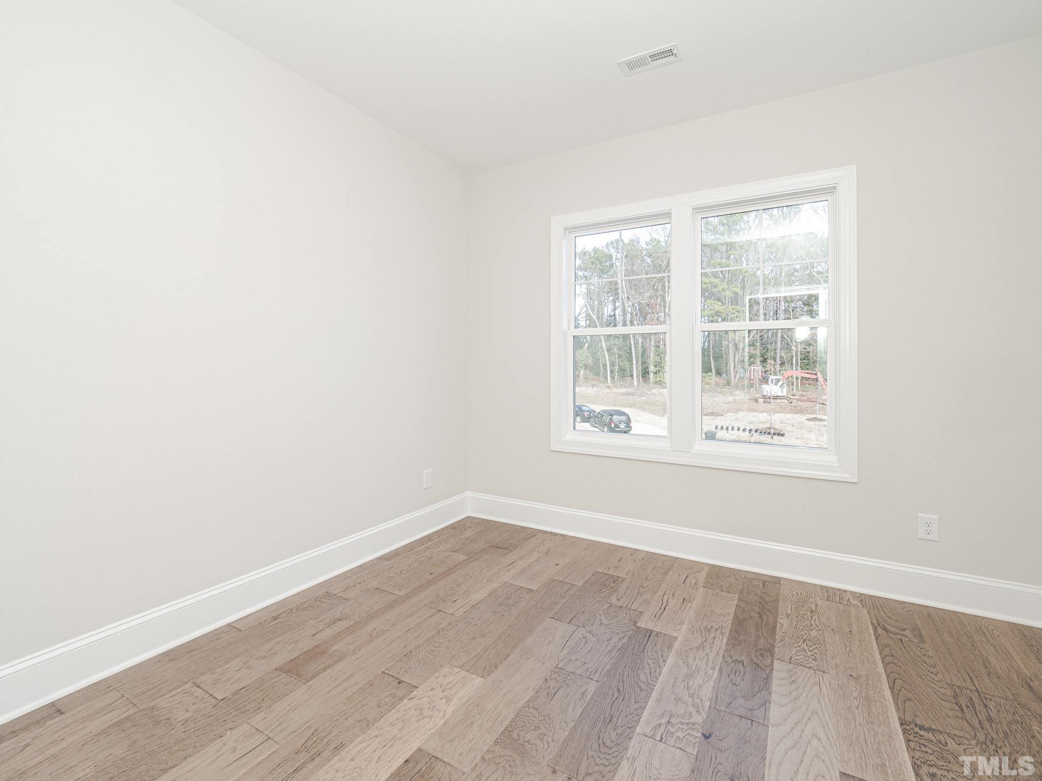 4920 Trek Lane Raleigh, NC 27606 - Photo 29 of 31 an empty room with wooden floor and windows