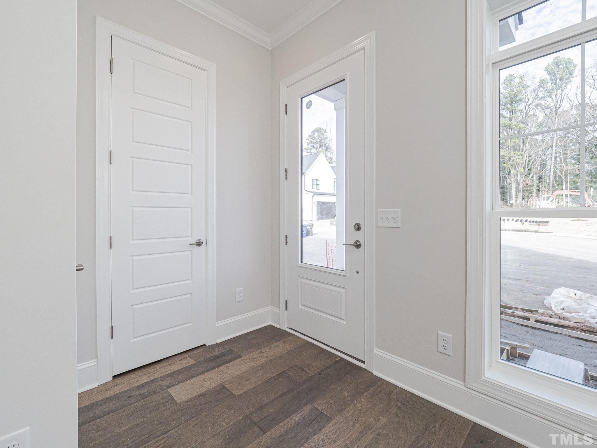 4920 Trek Lane Raleigh, NC 27606 - Photo 7 of 31 an empty room with wooden floor cabinet and windows