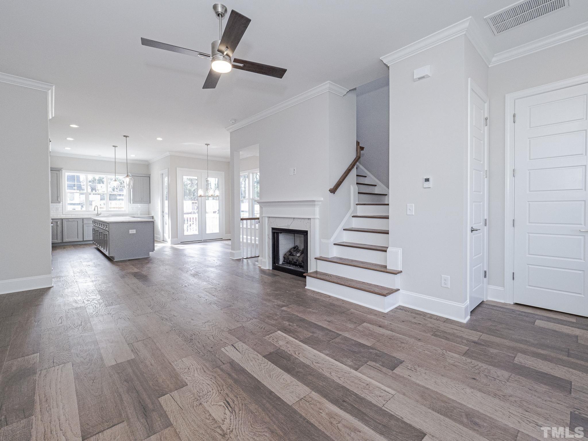 4920 Trek Lane Raleigh, NC 27606 - Photo 10 of 31 a view of a livingroom with wooden floor and a ceiling fan