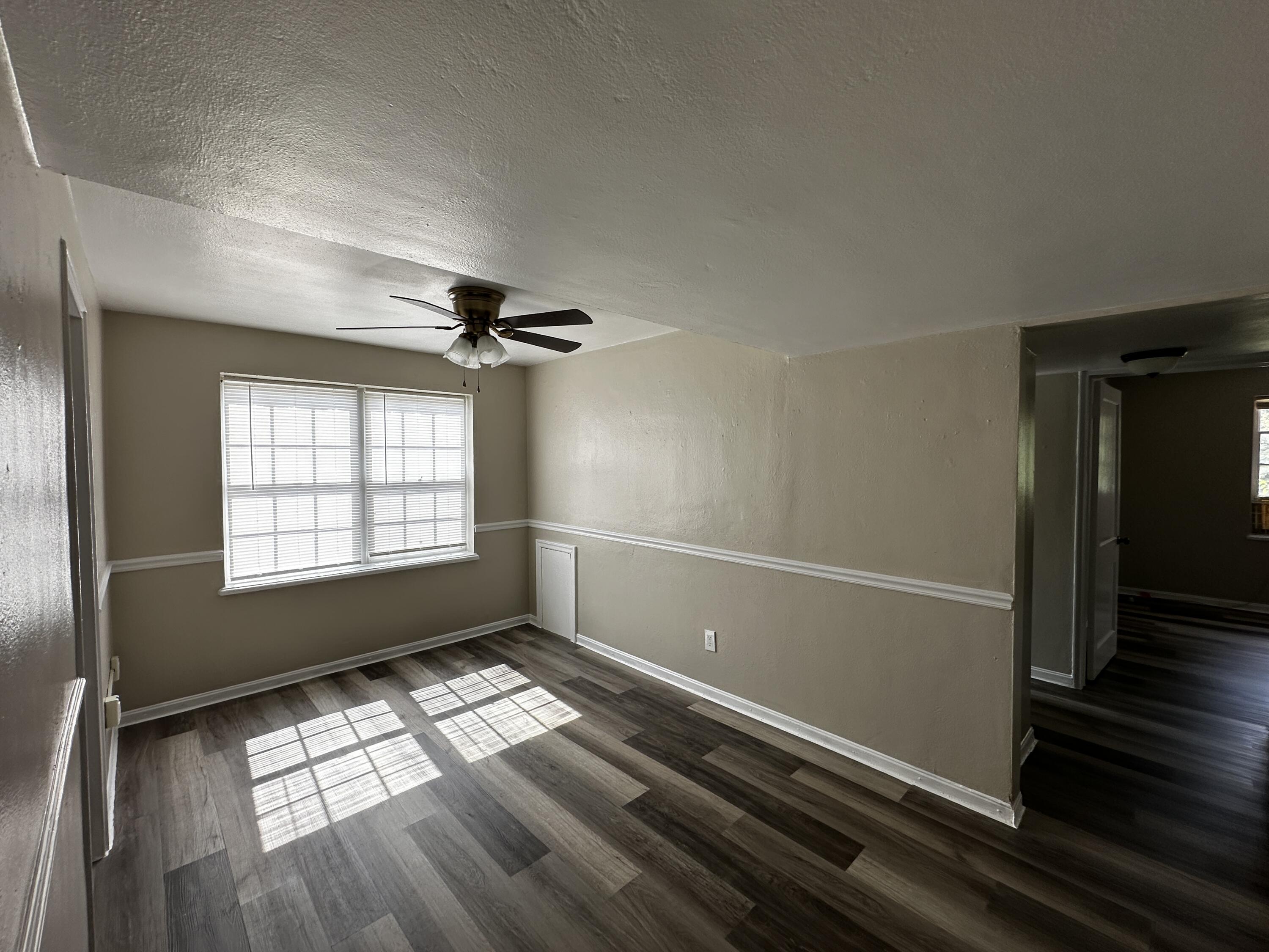 1728 Grandin Road Southwest, Unit 40 Roanoke, VA 24015 - Photo 4 of 9 a view of empty room with wooden floor and fan