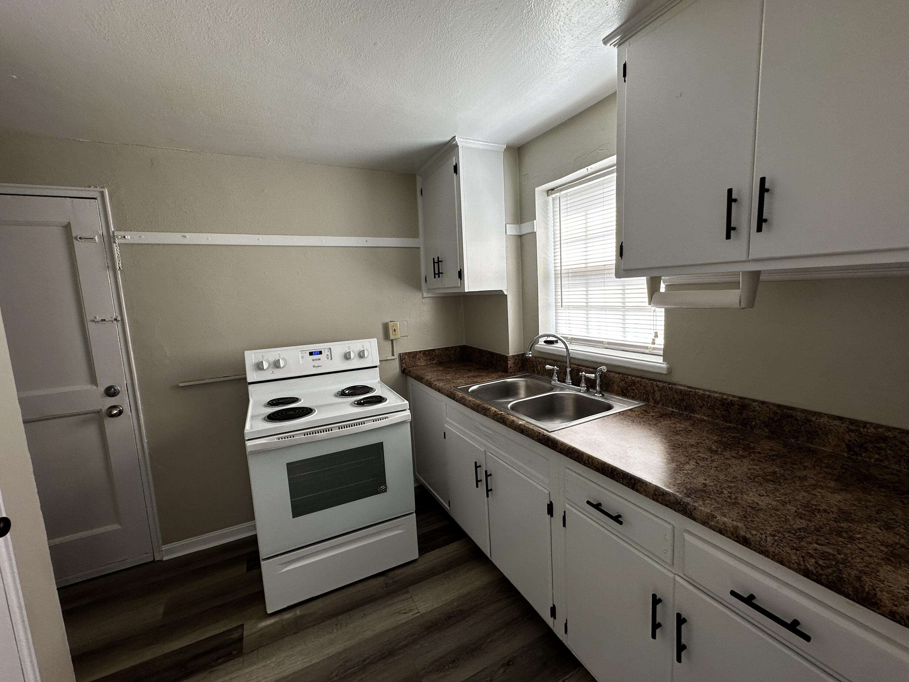 1728 Grandin Road Southwest, Unit 40 Roanoke, VA 24015 - Photo 5 of 9 a kitchen with a stove and a sink
