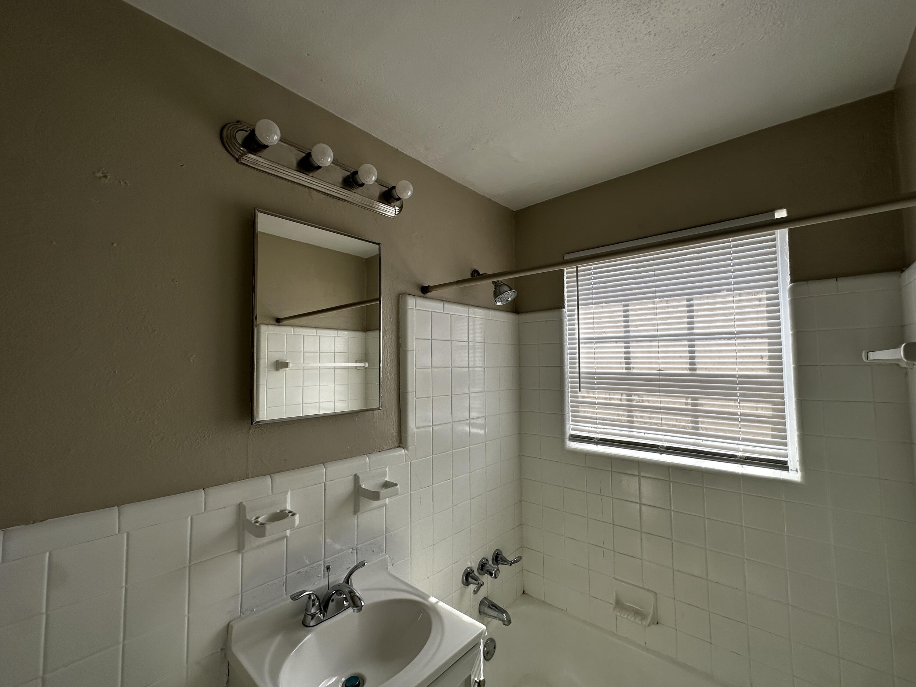 1728 Grandin Road Southwest, Unit 40 Roanoke, VA 24015 - Photo 6 of 9 a bathroom with a bathtub and shower