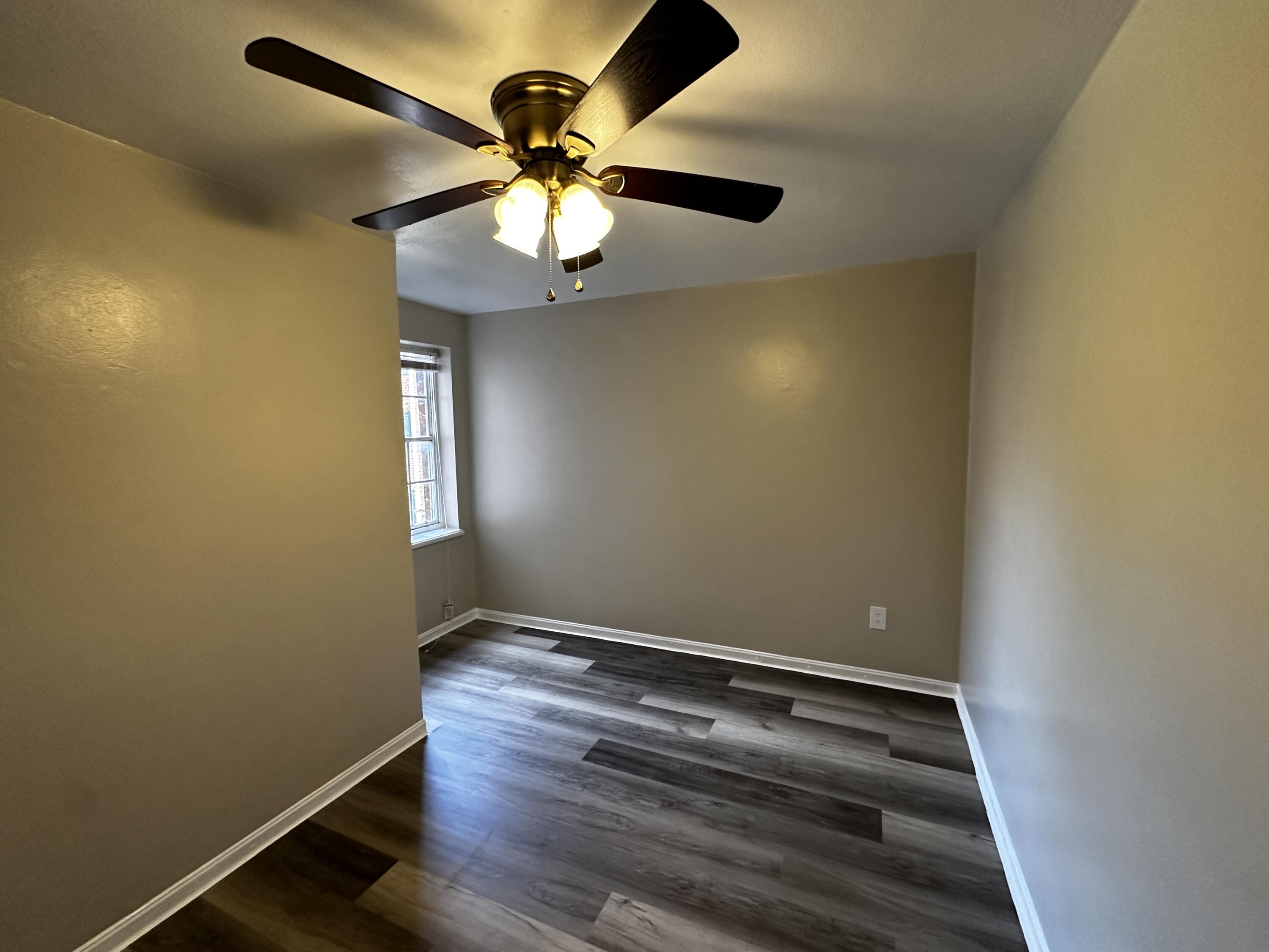 1728 Grandin Road Southwest, Unit 40 Roanoke, VA 24015 - Photo 9 of 9 en empty room with wooden floor and fan