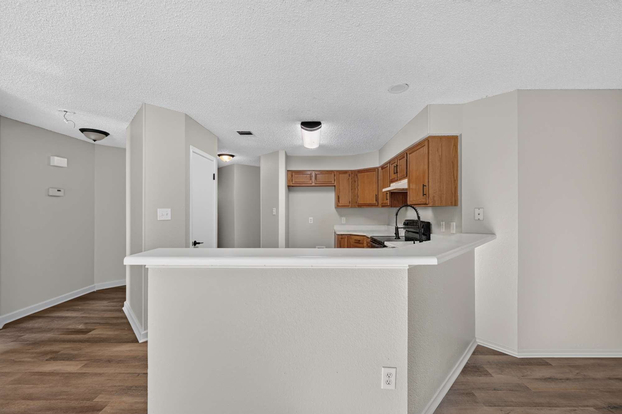 904 Nelson Ranch Road Cedar Park, TX 78613 - Photo 3 of 21 Timeless wood cabinetry and resilient plank flooring anchor this open and functional kitchen space.