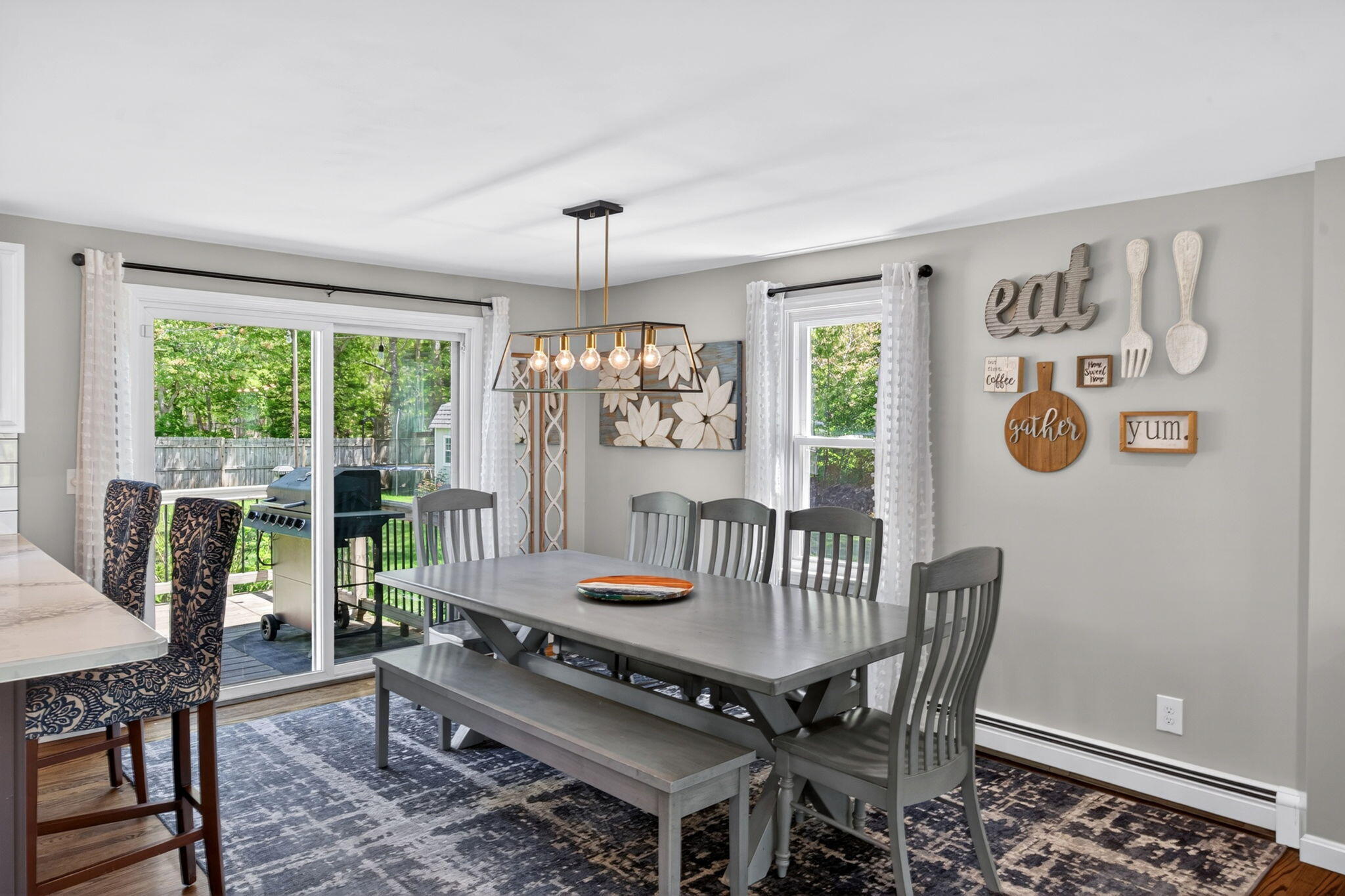12 Sarah Lawrence Road Sandwich, MA 02563 - Photo 7 of 54 a dining room with furniture a rug and a chandelier
